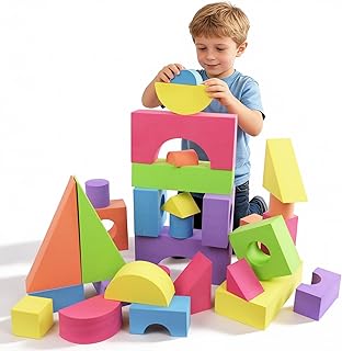 Child stacking large colorful foam blocks